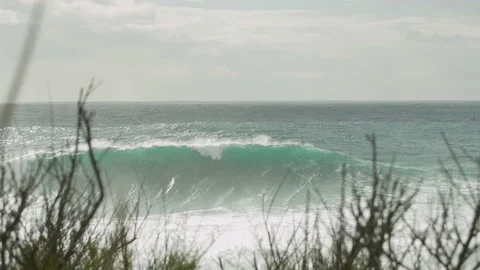 Slow motion of ocean water waves arising from calm surface on cloudy morning Stock Footage 156082449