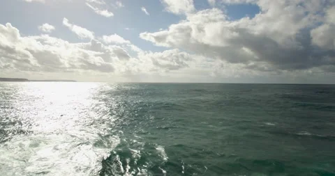 Slow motion of ocean water waves rippling in slight breeze with sun reflection Stock Footage 156101534