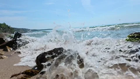 Slow Motion Ocean Wave Crashing Against Rock with Splashing Water Droplets Stock Footage 308514053