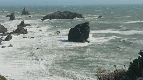 Slow motion ocean wave crashing on sea stack along California coast Stock Footage 345367137