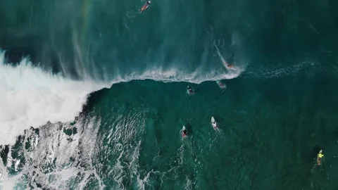 Slow Motion Ocean Wave Curling and Breaking on top of Surfers in Deep Blue Water Stock Footage 326014297