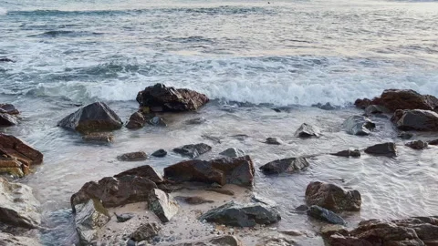Slow motion ocean wave form view washing on rocky onshore. Stock Footage 246518075