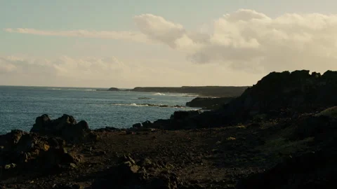 Slow Motion Ocean Wave, sandy coastline with hills Stock Footage 247072254
