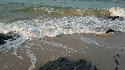 Slow motion ocean wave splashes across a big rock in the middle of the rough exo Stock Footage 165986980