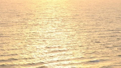Slow motion of ocean wave with sunset or sunrise light, relaxation and travel co Stock Footage 102931497