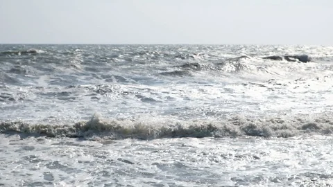 Slow motion of ocean wave with sunset or sunrise light, relaxation and travel Видео 102931586