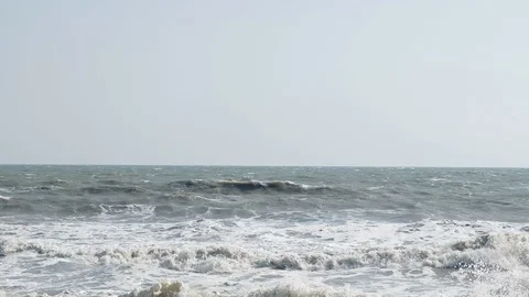 Slow motion of ocean wave with sunset or sunrise light, relaxation and travel Видео 103129642