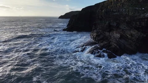 Slow Motion Ocean Waves Along Dark Rocky Coastline in 4K Stock-Footage 332944681