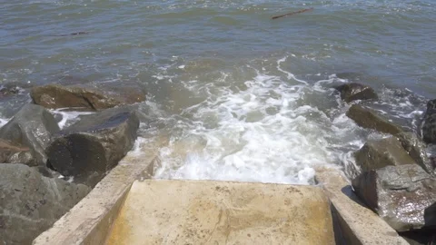 Slow motion of ocean waves crashing into rock Stock Footage 109407763