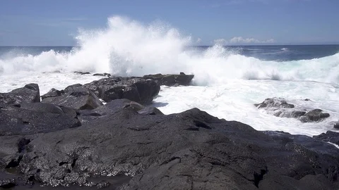 Slow Motion Ocean Waves hitting and Splashing on Volcanic Rock Stock Footage 118392178