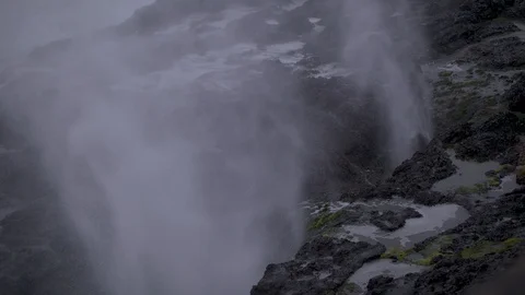 Slow-Motion Ocean Waves Shooting Up through Rocks on the Coast Stock Footage 88718196