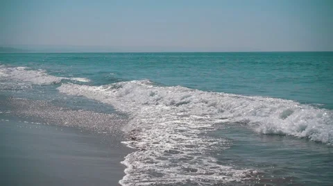 Slow Motion Ocean Waves with Sun Reflection Stock Footage 55244007