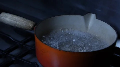 Slow motion - Old cast iron pan full of boiling water Stock Footage 86541297