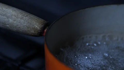 Slow motion Old cast iron pan of boiling water close up boiling, rolling boil Stock Footage 86541438