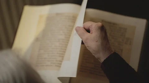 SLOW MOTION: Old human reading a book. Close up Stock Footage 43657717