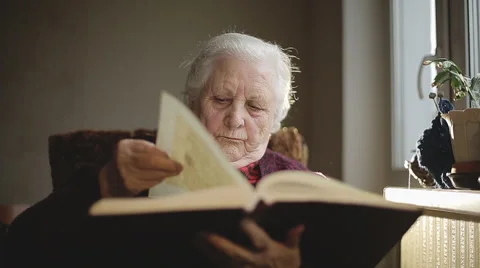 SLOW MOTION: Old human reading a book. Stock Footage 43661368