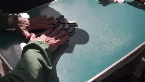 Slow motion Old men play domino game on a blue picnic table 動画素材 172435886