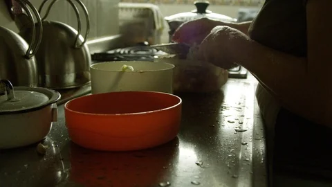 Slow motion of old woman's hands shredding vegetables Stock Footage 87813628