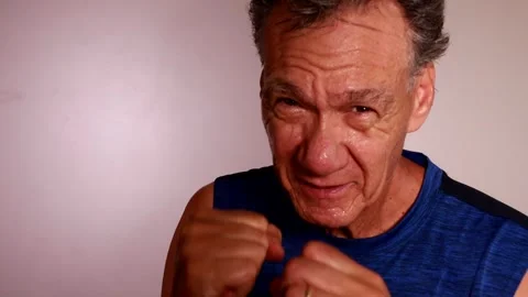 Slow Motion of an older man shadow boxing Stock Footage 254735391