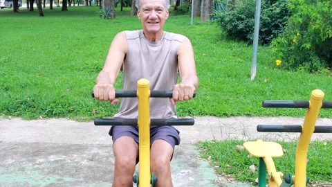 Slow Motion of an Older Man working out at an Outdoor Fitness Park Video stock 327227769