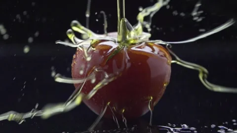 Slow motion of olive oil splash on tomato Stock Footage 262459486