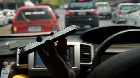 Slow motion, one person using mobile phone in car driving Stock Footage 89796065