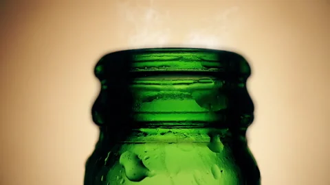 Slow motion opened green beer bottle with smoke moves a bit Stock Footage 144666754