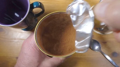 Slow motion – Opening a pack of cocoa / drinking chocolate powder. Stock Footage 106188515