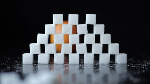 Slow Motion Orange Breaking Through Wall of Stacked White Sugar Cubes. Heal.. Video stock 321422731