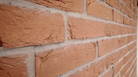 Slow motion of an orange brick wall filled with gray concrete. Stock Footage 269506762