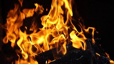 Slow motion orange burning flame on a dark brick grill background Stock Footage 119823540