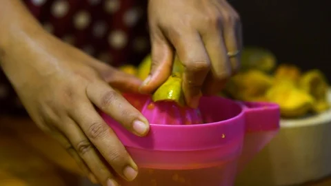 Slow motion, Orange squeezed by hand to make juice Stock Footage 111142352