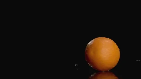 Slow motion orange twisting on dark background with copy space at the left Stock Footage 74068903