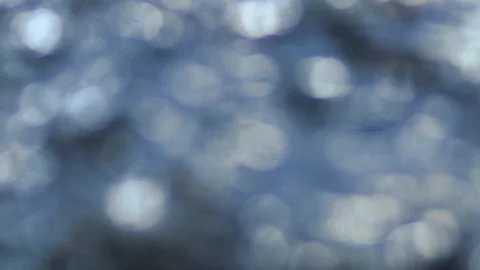 Slow motion: Out of focus raindrops hitting the ground create beautiful bokeh Stock Footage 93161294
