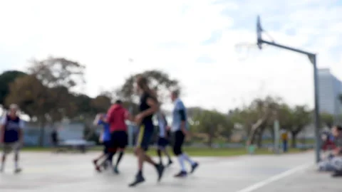 Slow motion out of focus shot of basketball game on an open air court Видео 132646436