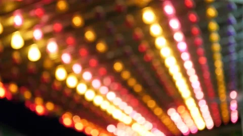 Slow motion out of focus shot of bright carnival lights flashing Stock Footage 148168506