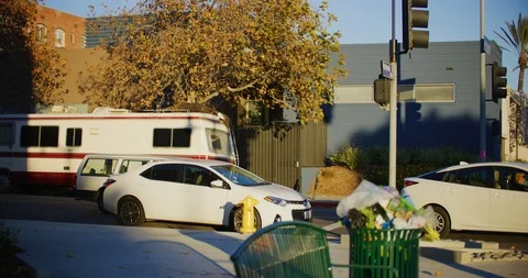 Slow motion of an over flowing trashcan on a windy day in Los Angeles, Stock Footage 115511468