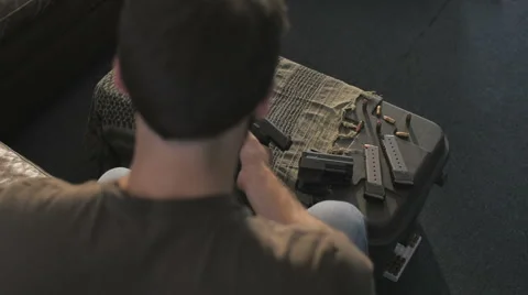 Slow Motion Over Head Cleaning .45 Caliber Semi-Automatic Gun Video stock 60664259