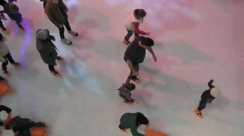 Slow Motion Overhead of children and families ice skating Stock Footage