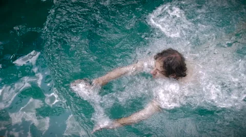 Slow motion overhead shot of a man swimming in a pool Slow motion Stock Footage 58931648