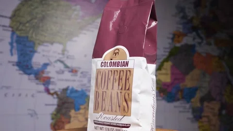Slow-motion of a packet of Turkish coffee against a world map Stock Footage 171448037