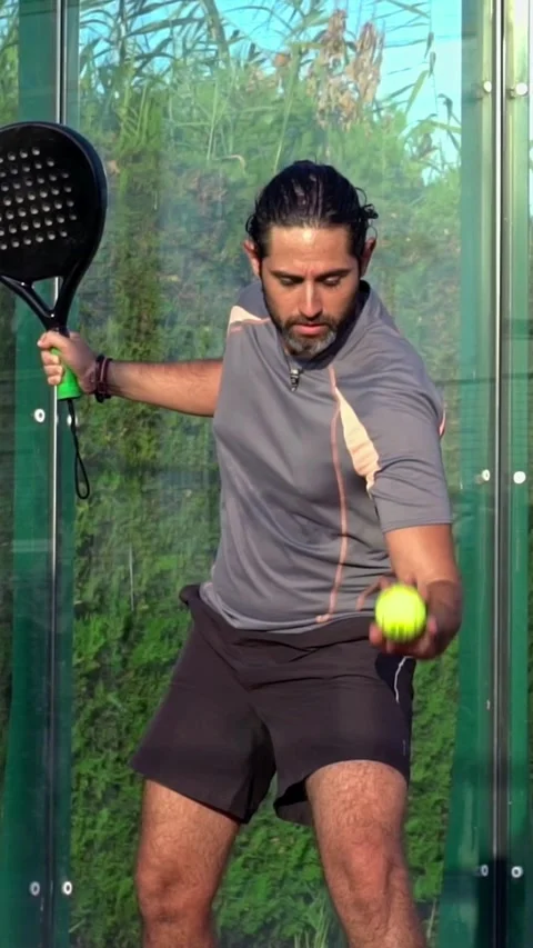 Slow motion of a paddle tennis player kicking the ball on an outdoor court. Stock Footage 310104495