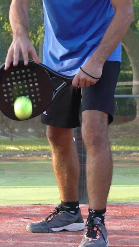 Slow motion a padel player who bounces the ball and serves in a match. Video stock 310104517
