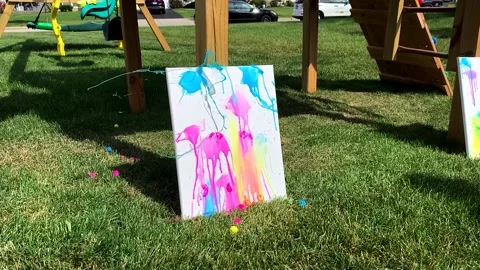 Slow Motion of Paintball exploding on canvas Stock Footage 155910032