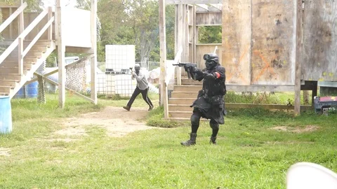 Slow Motion Paintball Player gets shot wearing skull face mask Video stock 123879714