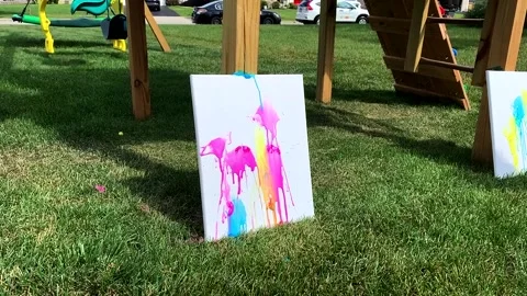 Slow Motion of Paintball's thrown at canvas to make art Stock Footage 155910031