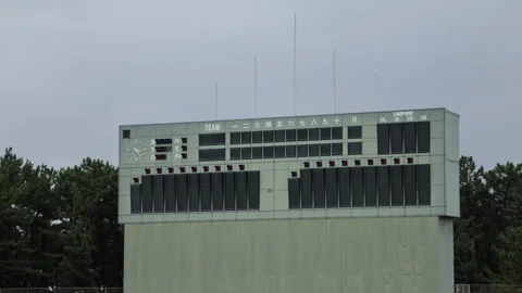 Slow motion pan across a baseball stadium scoreboard in Japan Video stock 348585449