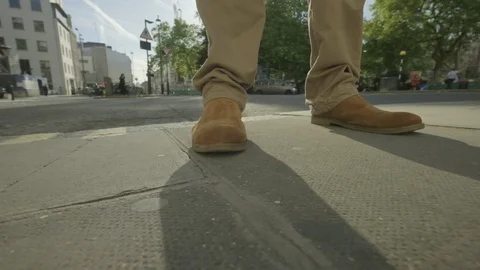 Slow motion pan around a man's feet Video stock 108353451
