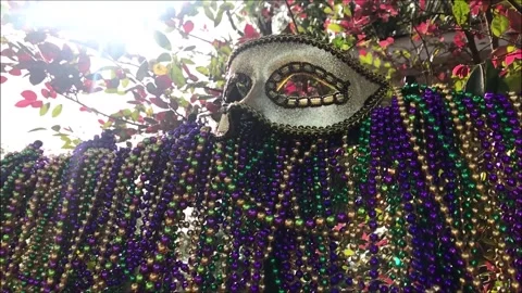 Slow motion pan of beads and fleur di lis and Mardi Gras Mask of iron Video stock 144004963
