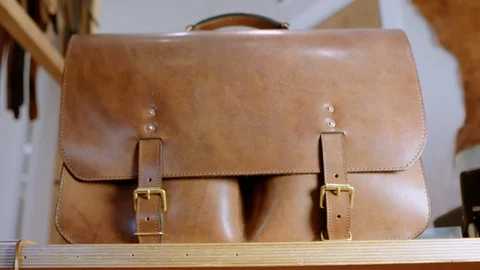 Slow motion pan of beautiful hand made leather satchel Stock Footage 96133054